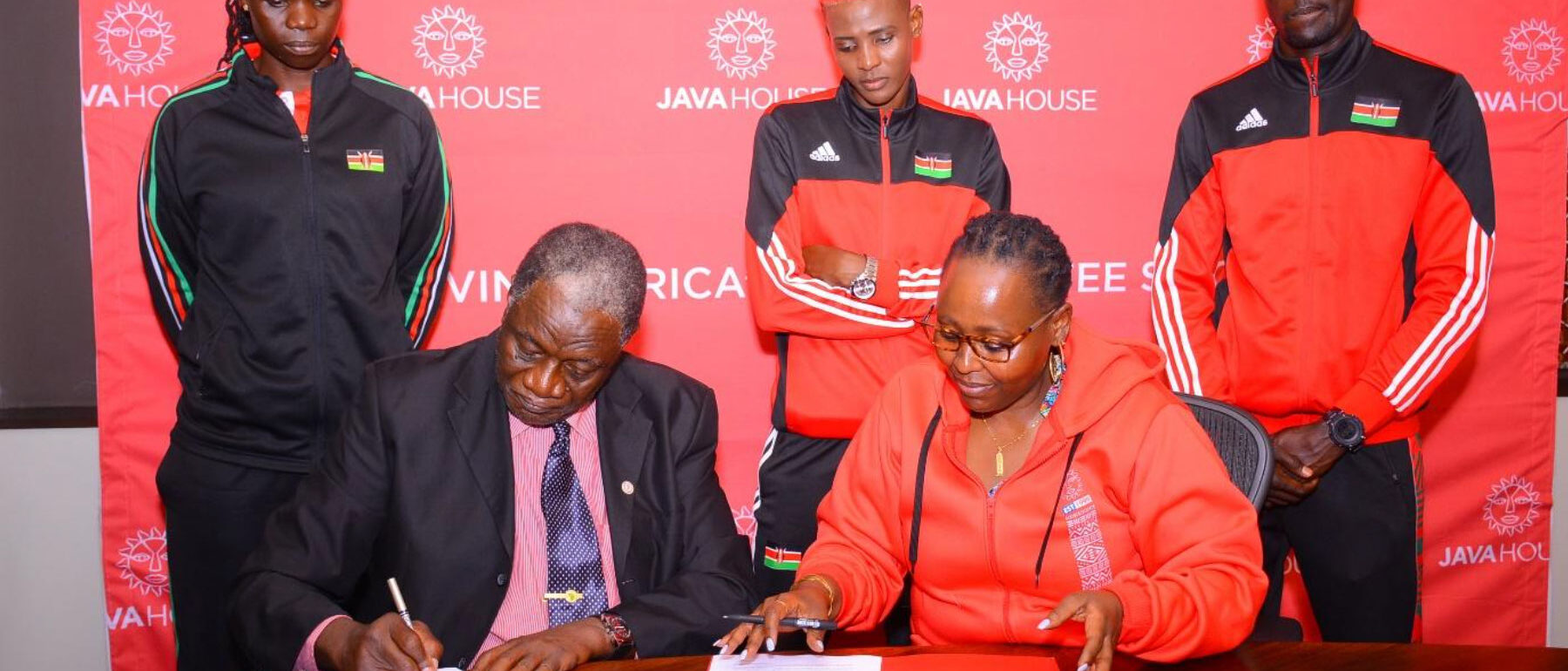 CEO Java House Priscilla signing sponsorship partnership agreement with Kenya Volleyball Federation President, Charles Nyaberi with Malkia strikers standing on the back | Java Foundation