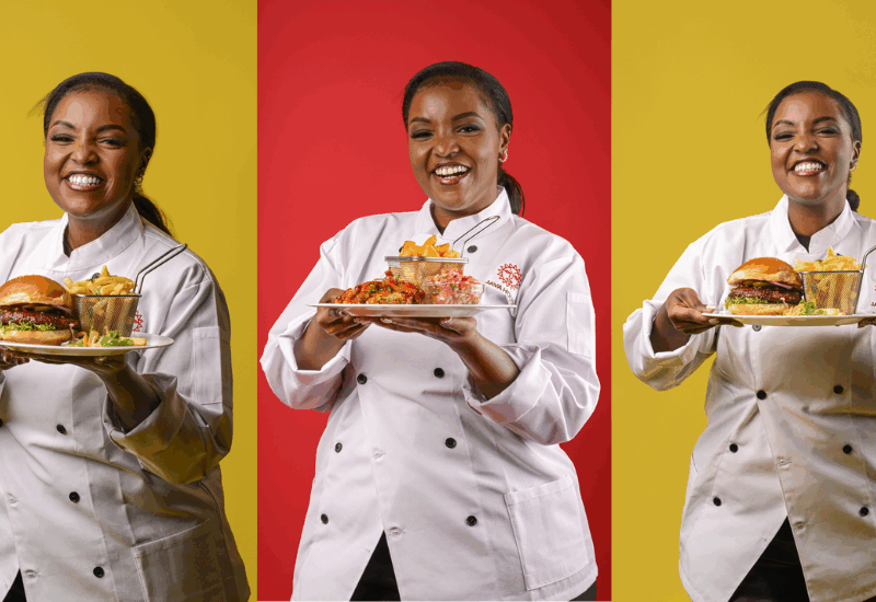 @Cooking with Jaz holding three plates two with Sticky Fried Chicken Burger and one with Mango Chilli Chicken Wings | Java Guest Chef Experience May 2025 edition